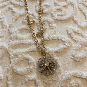 Gold starburst charm necklace